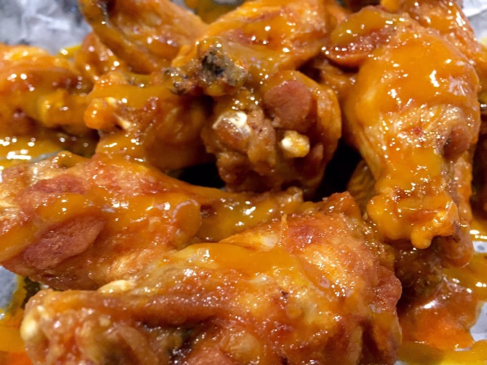 A close-up of traditional wings coated in sauce.