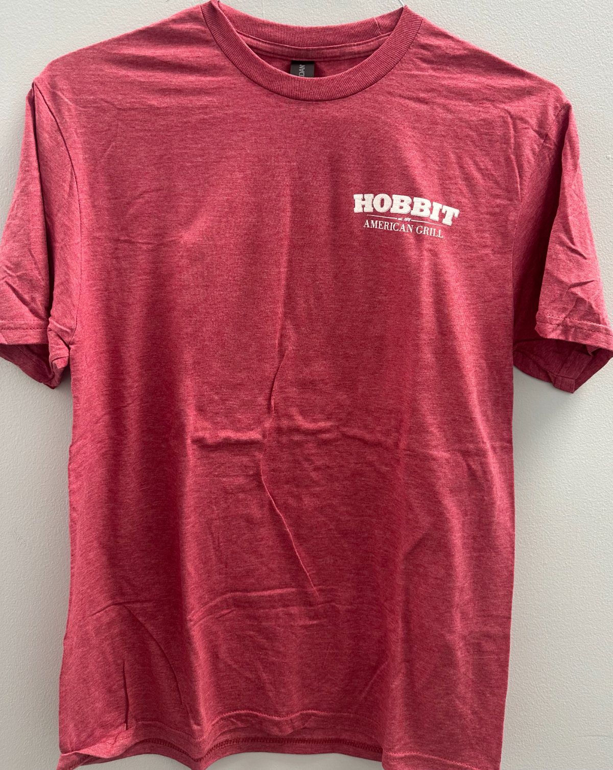 A heather garnet T-shirt with the Hobbit American Grill logo printed small on the chest.